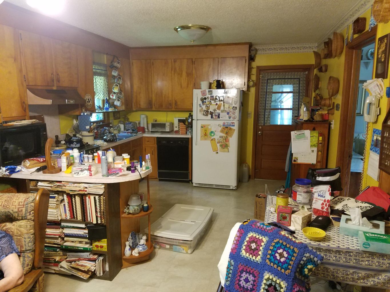 View of kitchen with a lot of items and wooden cabinets