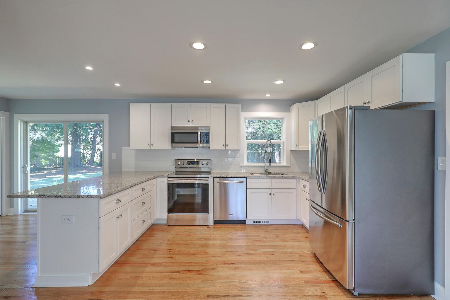 View of the kitchen with white theme