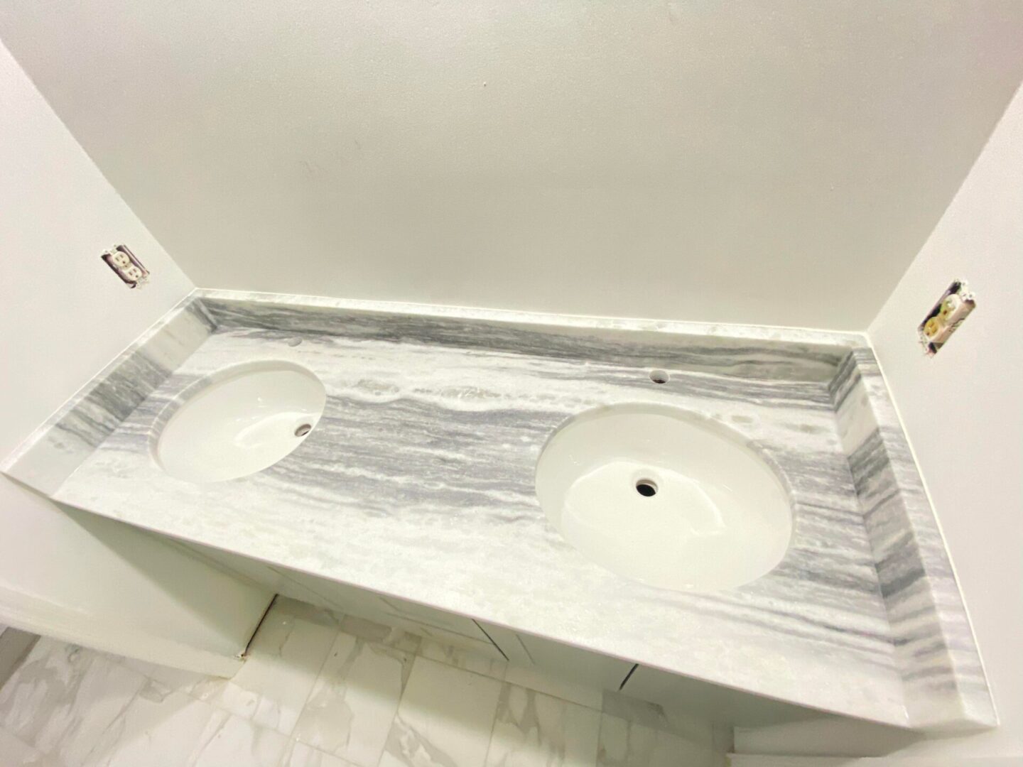 A modern sink under construction with white marbles