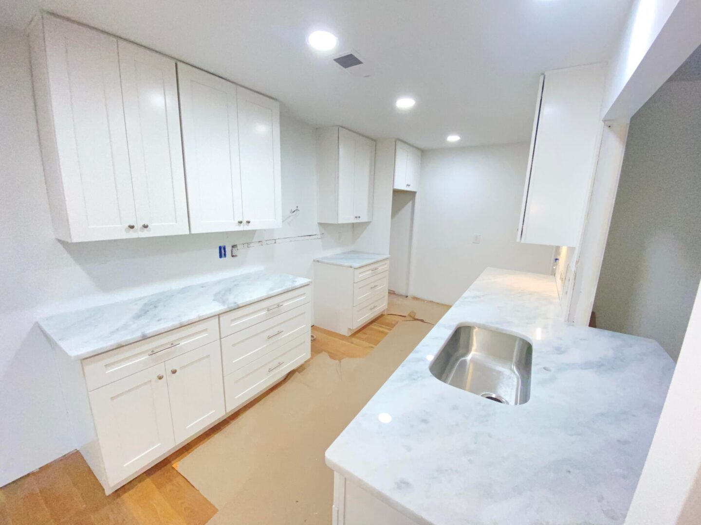 Closeup view of kitchen with white cabinets